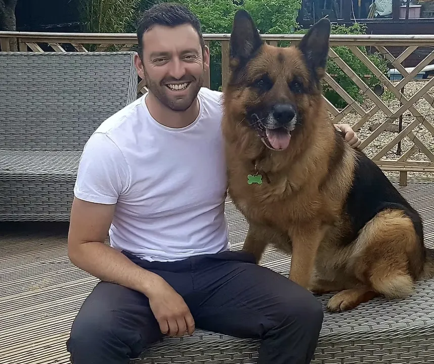 Adam Daines with a German Shepherd